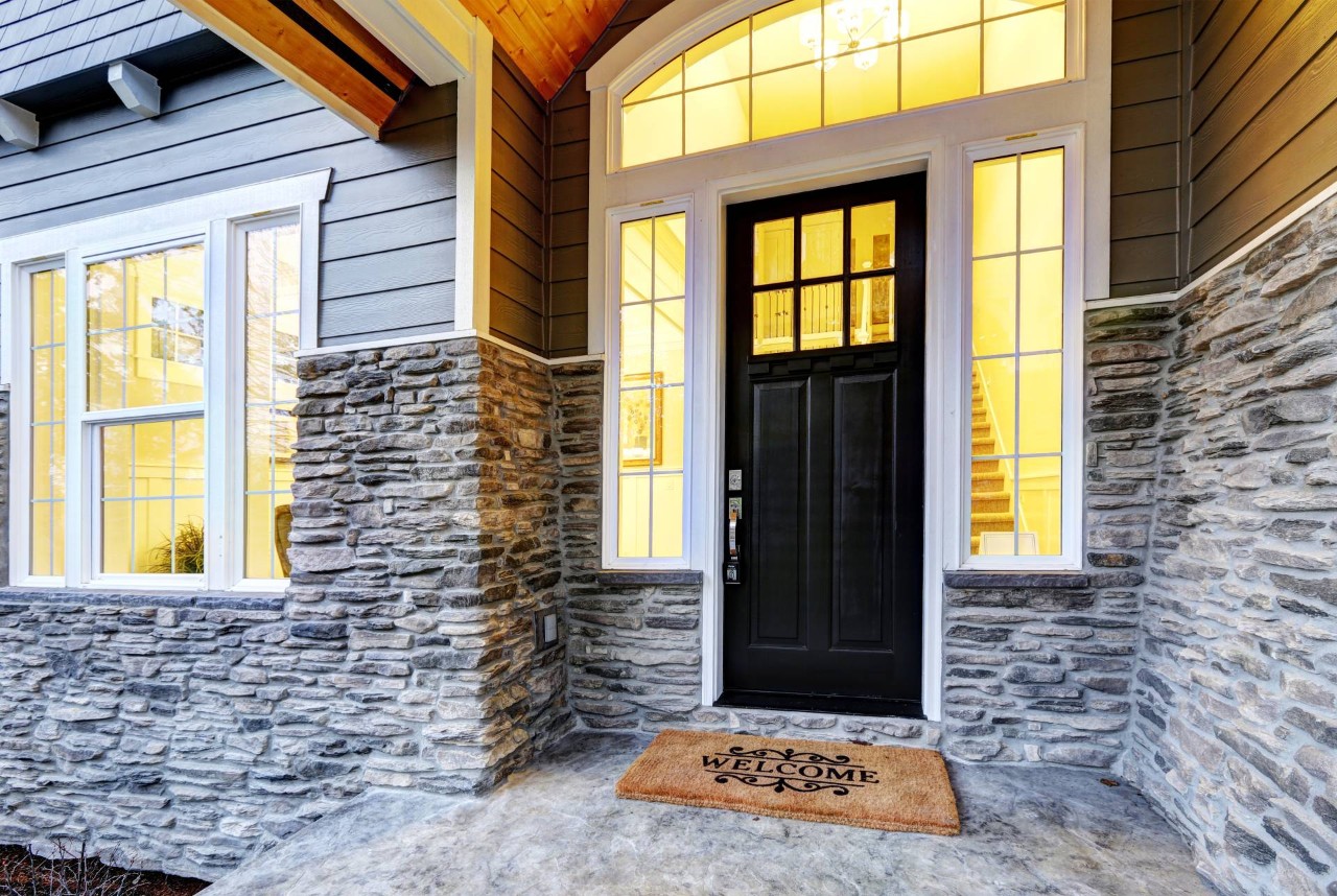 Front porch of a home with sidelight windows near Flower Mound, TX