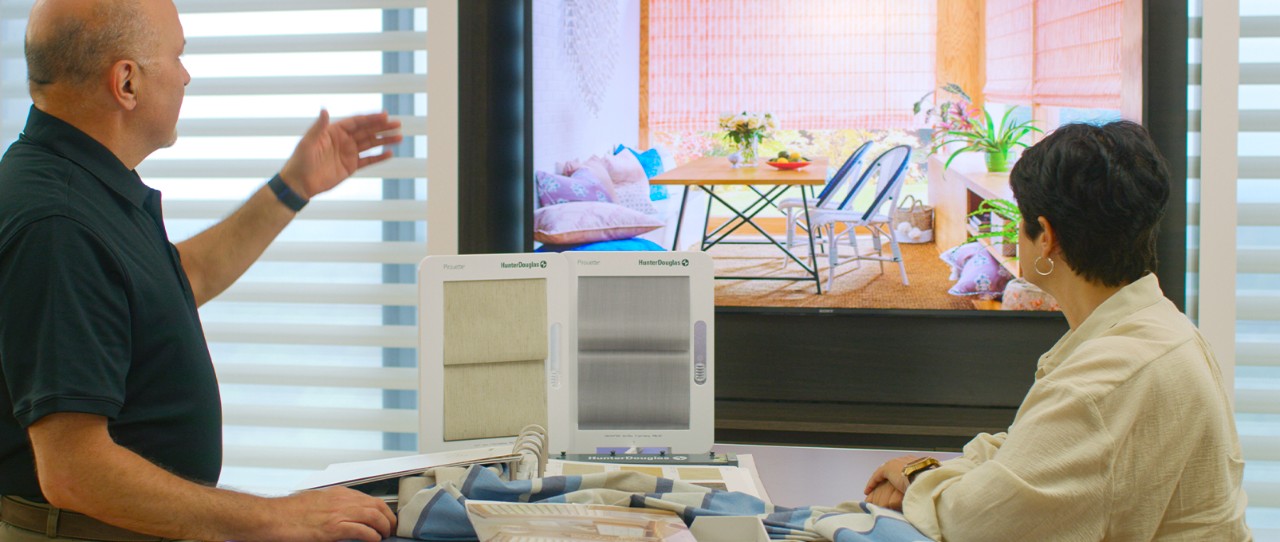 Man and woman looking at shade samples in a showroom.